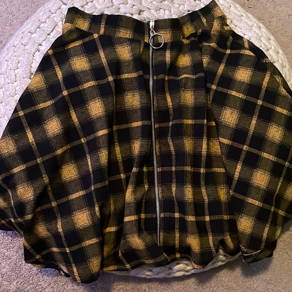 Yellow and black alternative cross patterned zip up skirt.
